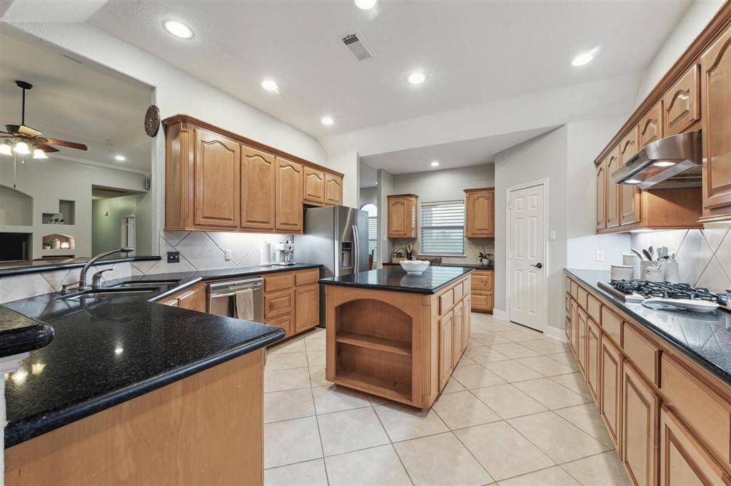 Enjoy cooking on the gas cook top with extra prep space on the island.