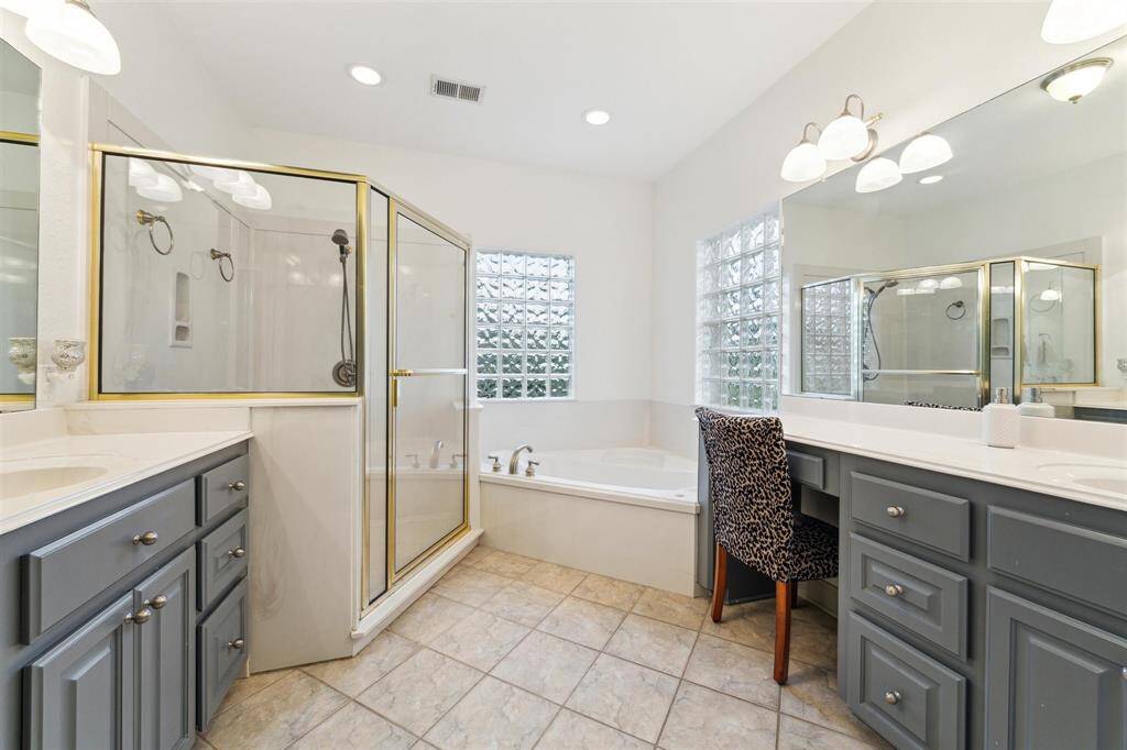 The primary bathroom has 2 vanities with sinks, separate oversized shower and a soaking tub.