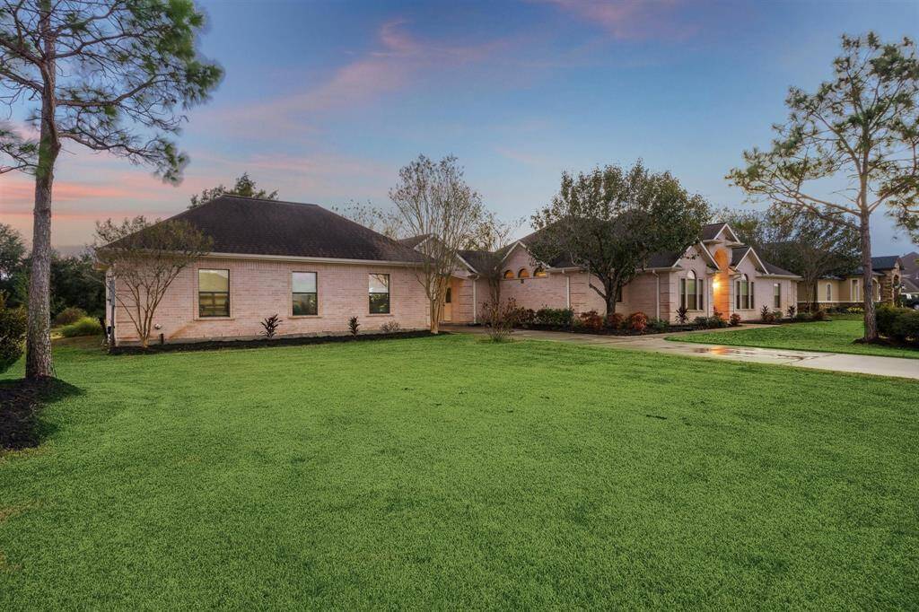 This view highlights the oversized 3 car garage with a porte-cochere.