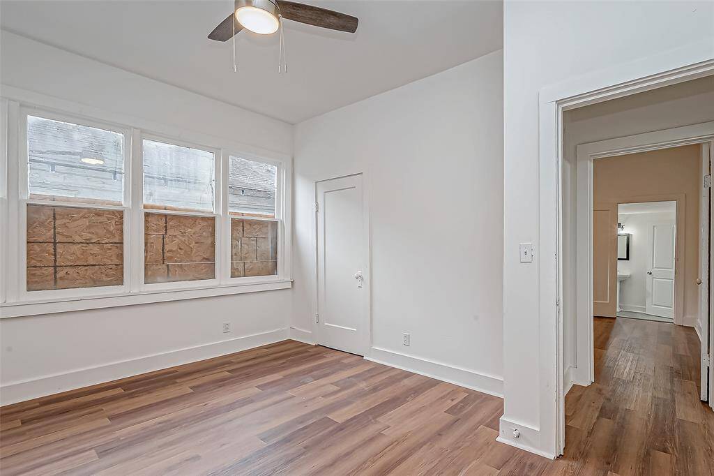 From this viewpoint, the spacious layout of the bedroom is clear, providing flexibility for furniture arrangements. The clean lines and ample natural light make the space feel bright and welcoming, offering a peaceful setting for rest or creativity.