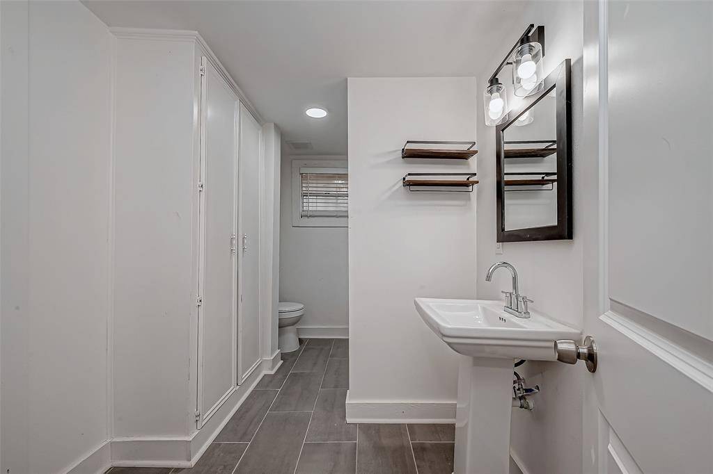 From this angle, the bathroom’s thoughtful layout is evident, with the toilet area subtly tucked away for privacy.