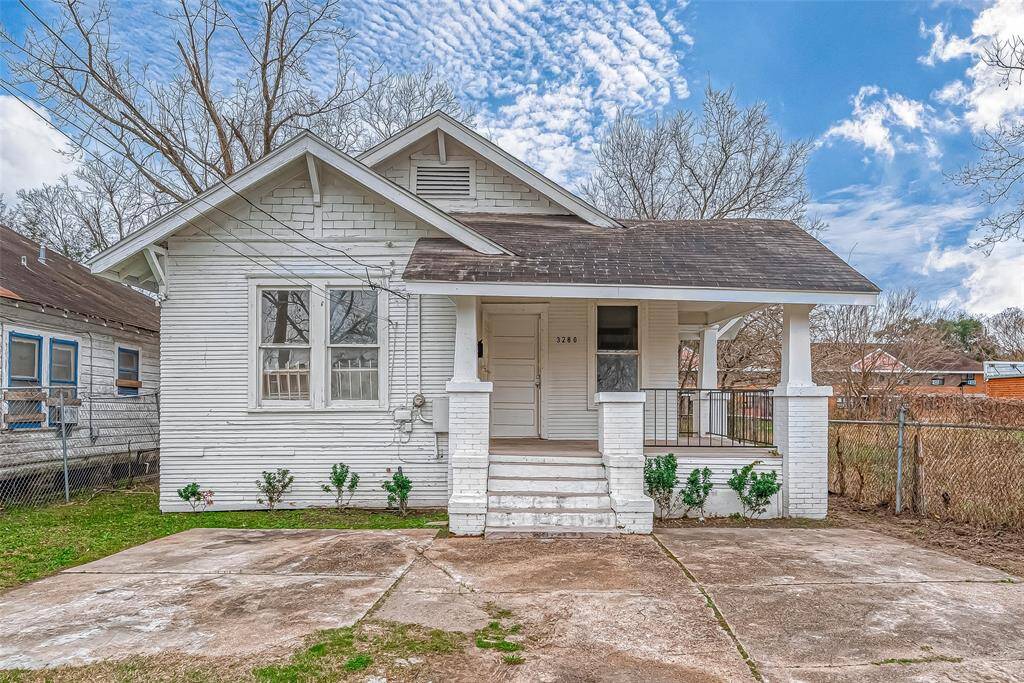 This charming home welcomes you with its classic white wood exterior and an elevated entryway. A short set of steps leads to the covered front porch, a perfect spot to enjoy the peaceful surroundings.