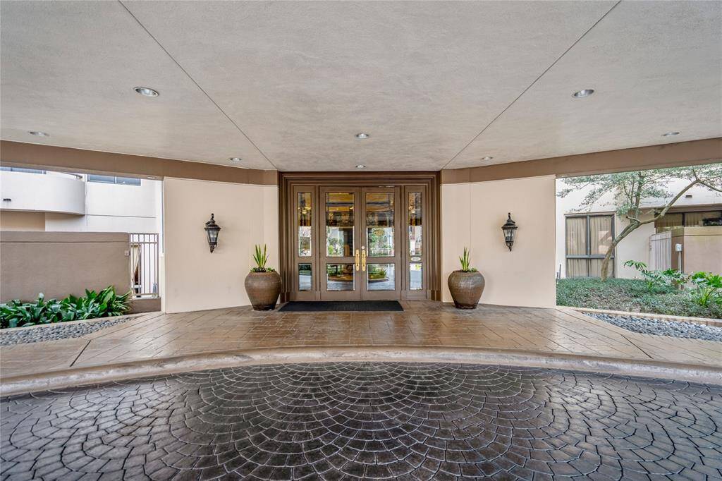 Visitors arrive at the main entry under a huge porte cochere.