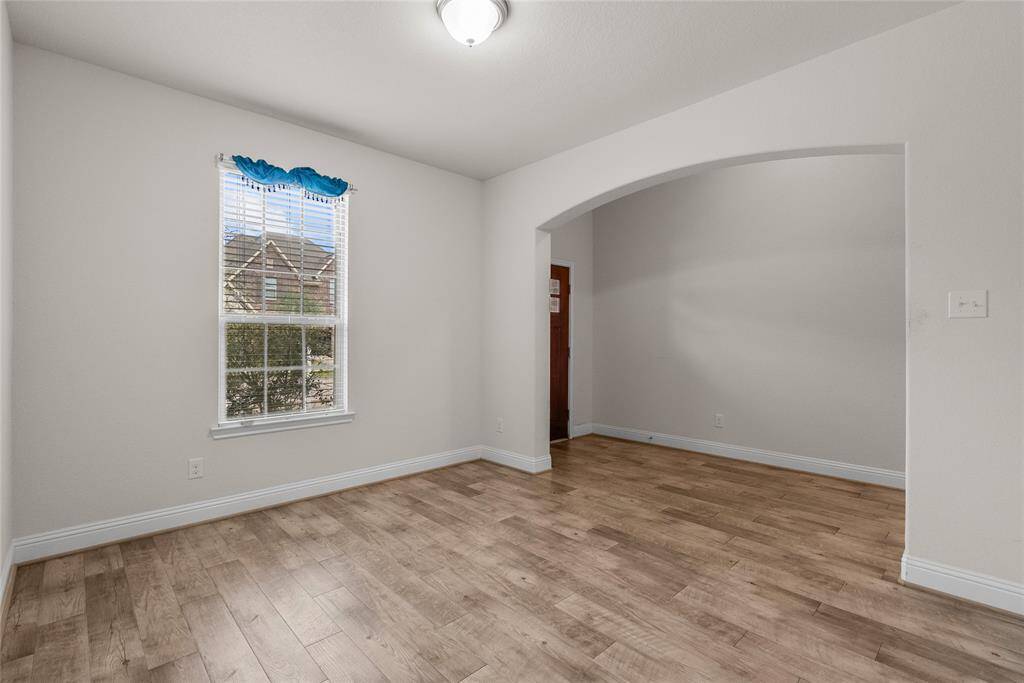 Versatile home office with ample natural light and modern flooring