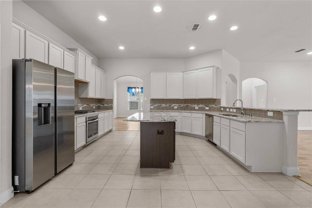 Spacious kitchen with archway passage to the formal dining