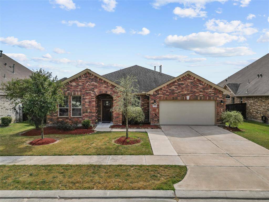 This is a TWO story brick home with an arched entryway, a two-car garage, and well-maintained landscaping.