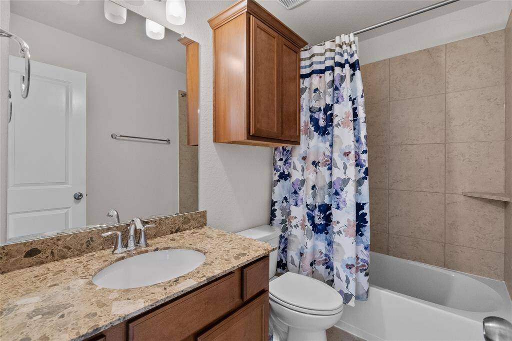 This is a well-maintained bathroom featuring granite countertops, wooden cabinets, a full bathroom upstairs