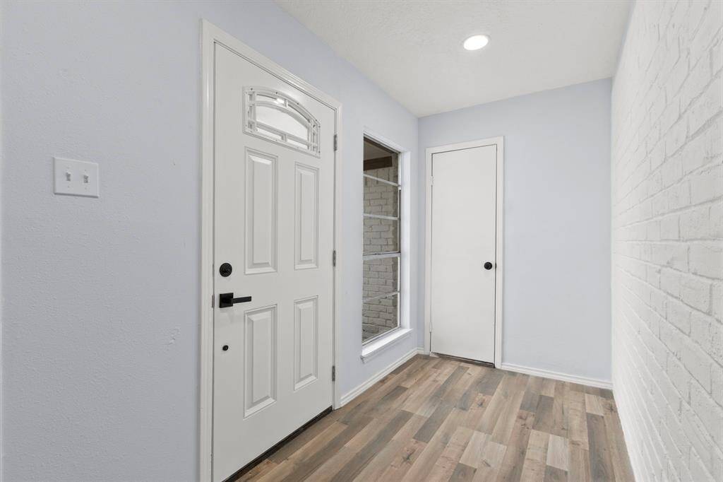 The foyer is bright and welcoming. There is also 1 of 2 garage access doors in the area, making this a great area for a bench and shoe cubby.