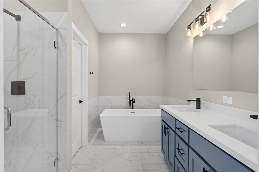 Primary bathroom features shower and bath
