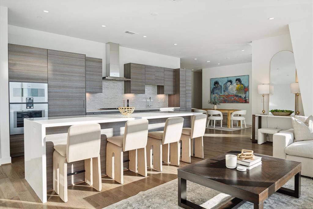 The expansive island is a huge benefit to the space. Additional counter space, a breakfast table, or spill over for guests when entertaining.