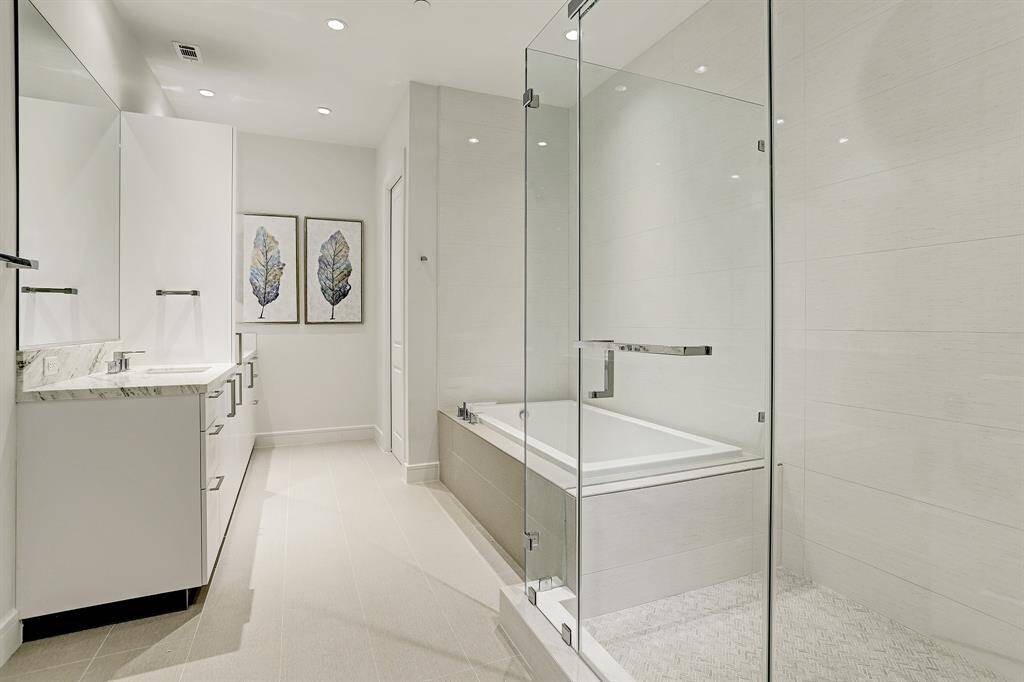 There is a frameless glass standing shower plus a oversized soaking tub for those long days.