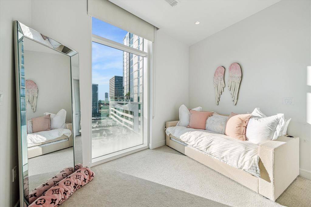 Secondary bedroom with large window and pull down shade.