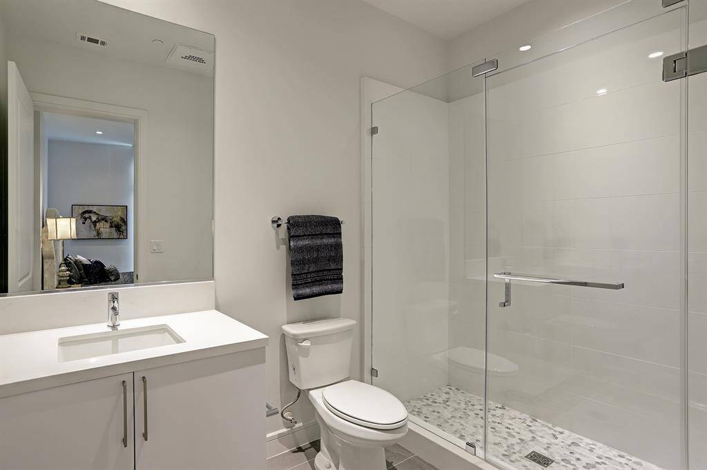 The en suite bath for the secondary bedroom is complete with standing shower.