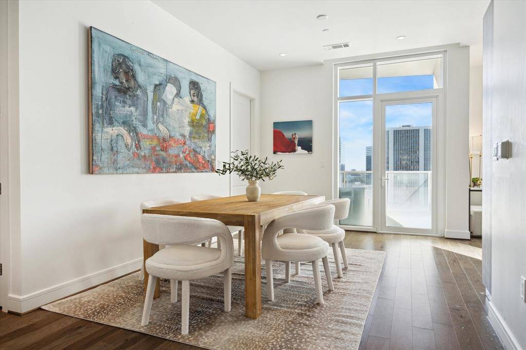 The dining area is just off the main living space for easy hosting. Access to the balcony is straight ahead.
