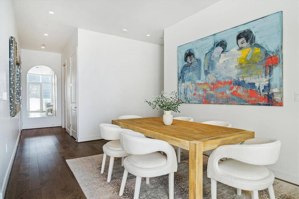 This unit features wood flooring in the common spaces, recessed lighting, and a half bath off the entry for guests.