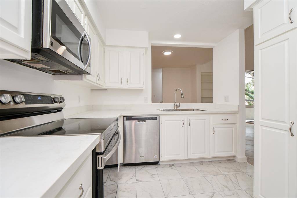 Counter space is everywhere you need it to be as you easily task in this truly workable kitchen.