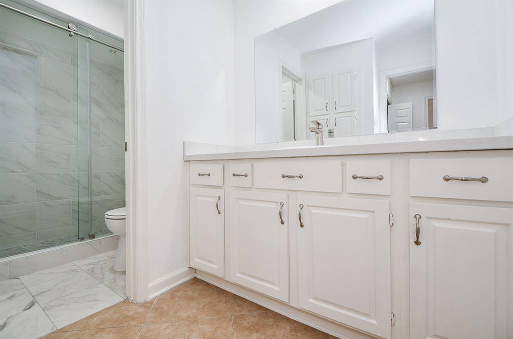 This primary ensuite walk-in closet offers basic and much appreciated shelving and hanging space.