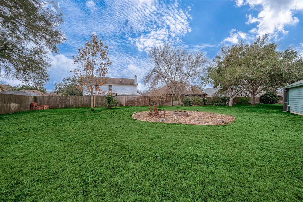 Huge fenced yard behind the pool enclosure.