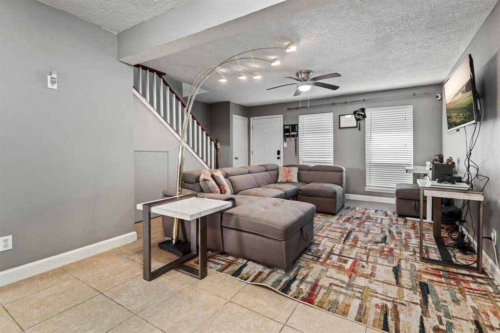 Welcome to Unit 50 in the Beverly Village Townhome community! The spacious living room is open to the dining area and kitchen and features modern finishes.