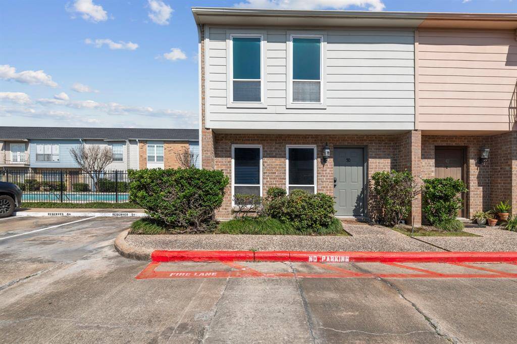 This 2 bedroom, 2.5 bath home sits directly next to the community pool and has two assigned parking spots seen here next to the unit. End unit with only one shared wall makes it ideal for privacy!