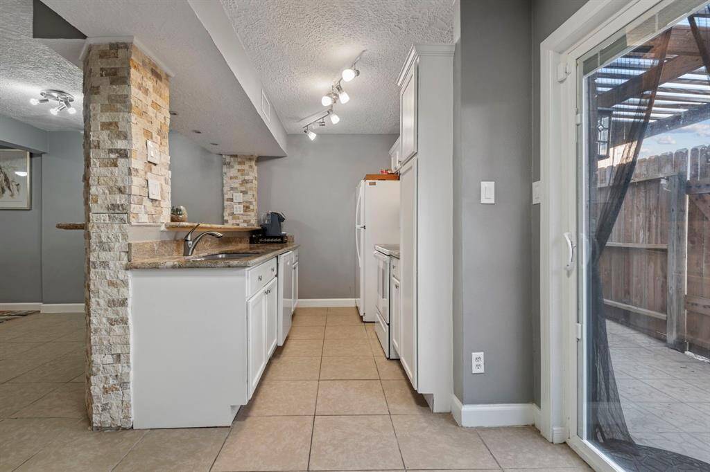 The kitchen features granite countertops, recently installed dishwasher, electric cooktop and stove, microwave, and fridge is included!