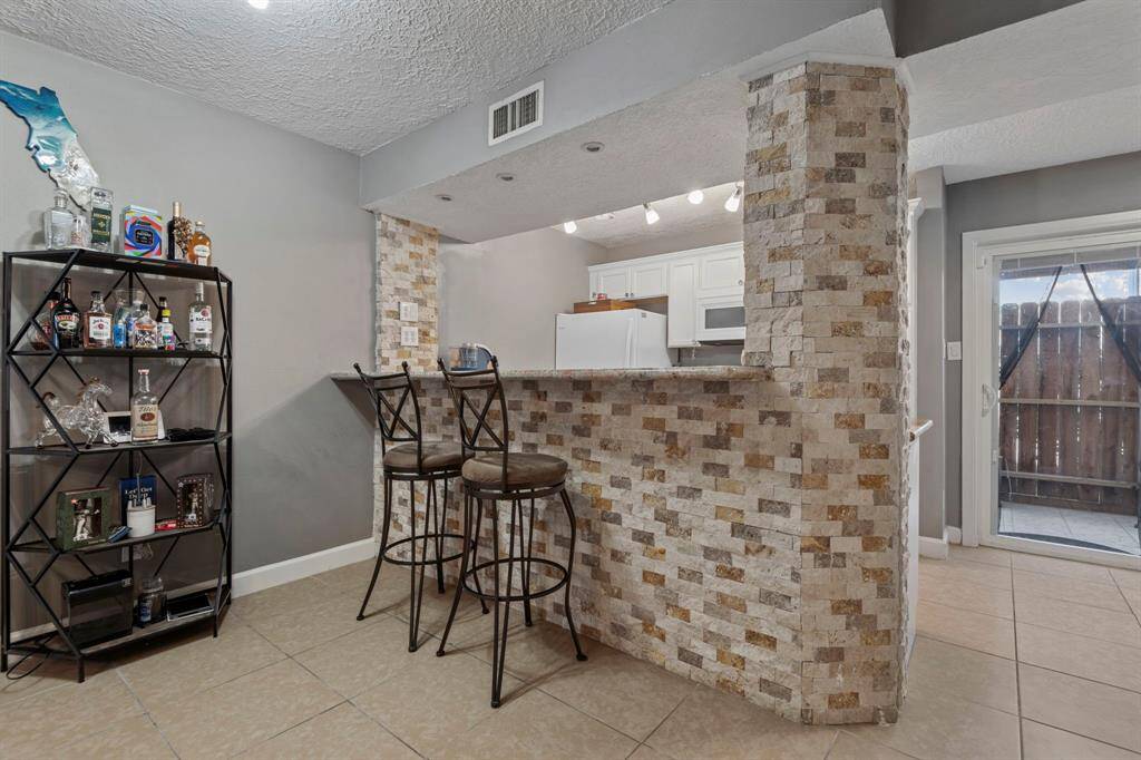 A great it in kitchen area with the breakfast bar and additional space in front of the kitchen.