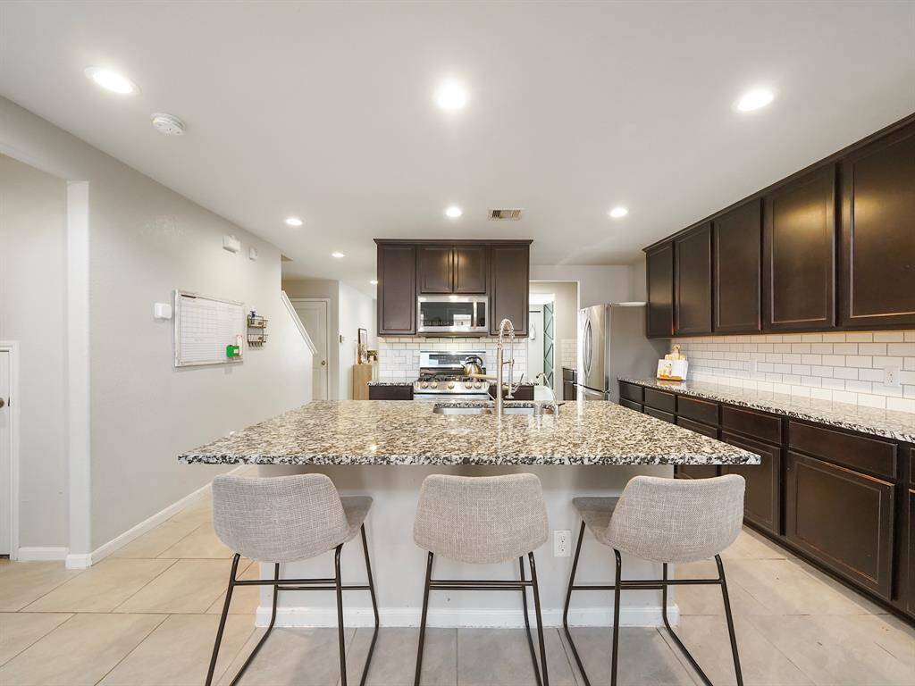 This open-concept kitchen is perfect for cooking and entertaining, featuring ample storage and a spacious kitchen island.