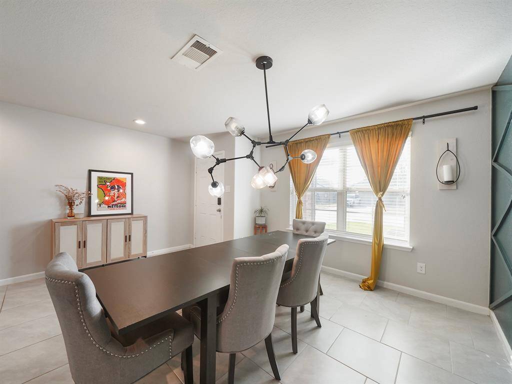 Elegant and Spacious Dining Room – This beautifully designed dining area features modern lighting, large windows with natural light, and stylish accents, perfect for hosting dinners and gatherings. The open layout seamlessly connects to the rest of the home, creating a warm and inviting atmosphere.