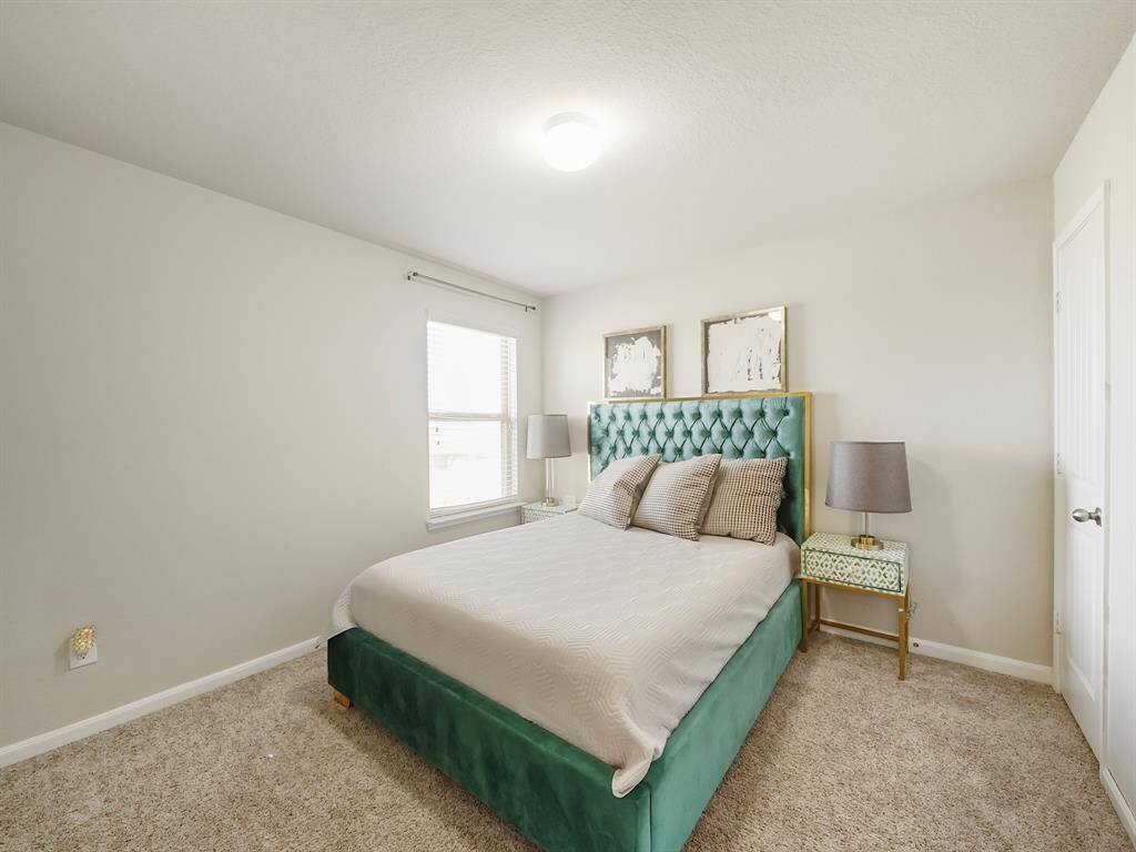 One of four upstairs bedrooms, this versatile space is perfect for a home office, study, or personal gym.