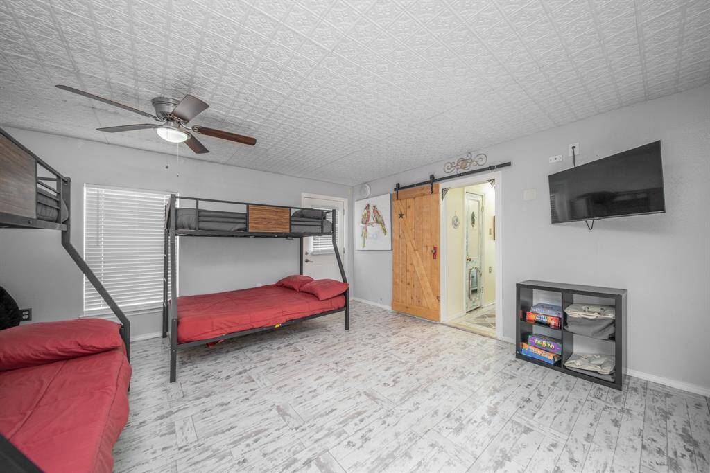 Bedroom 2 has plenty of space for bunkbeds while still allowing plenty of play room. The bedroom opens to a second bath located behind a barn door.