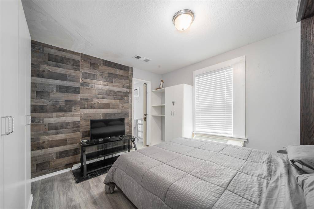 Bedroom 1 boasts a gorgeous accent wall and a built-in wardrobe.