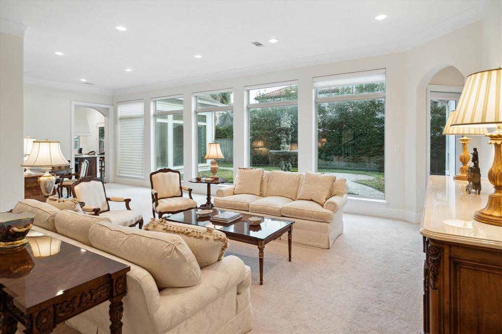 What a great view of the Backyard from the Living Room - glass transoms above the expansive windows allow for even more natural light to enter the space!