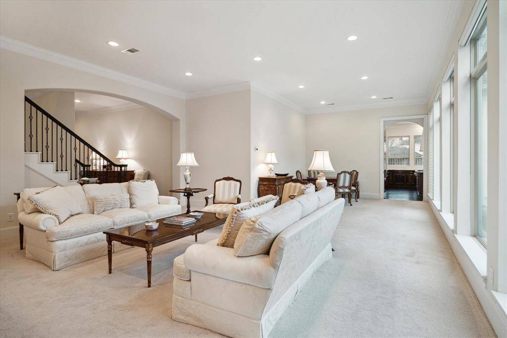 The Living Room is adjacent to the Dining Room and Kitchen entry.  Notice the gracefully arched opening details from the Front Entry Hall to the Living area.