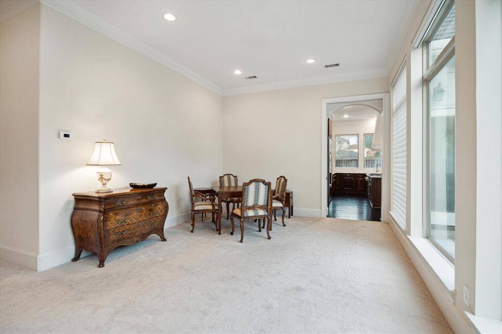Located between the Living and Kitchen areas is the DINING ROOM (14 X 13) with its carpeted flooring, crown/base molding, painted walls, recessed lighting and oversized window overlooking the backyard garden.