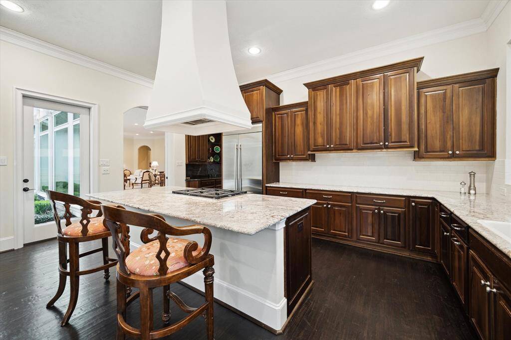 Closer Kitchen view of the clean lines of the stained wood cabinets/drawers and gleaming granite counters with white subway tile backsplashes.  A great Kitchen plan to allow for a plenitude of counter and storage space.
