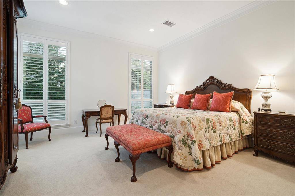 Located just off the Living Room is the elegant PRIMARY SUITE (19 X 16) features carpeted flooring, three large windows with plantation shutters, crown/base molding, painted walls, recessed lighting and en suite bath.