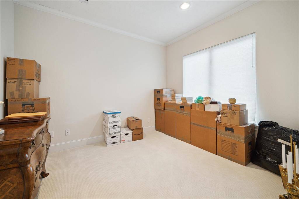 One of three upstairs GUEST BEDROOMS - this one (12 X 10) features carpeted flooring, window with shade, recessed lighting, crown/base molding, closet with hanging compartments and En Suite Bath.