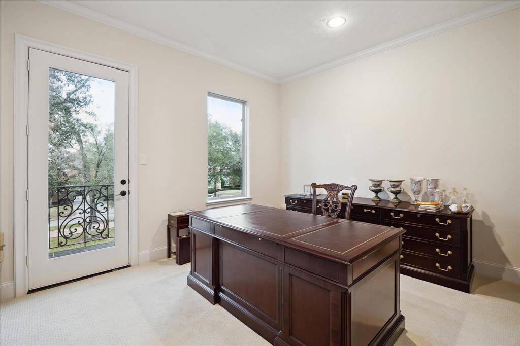 The third upstairs GUEST BEDROOM (15 X 12) features carpeted flooring, oversized window, glass front door to outdoor balcony, crown/base molding, recessed lighting, walk-in closet with hanging compartments/shelving and En Suite Bath.