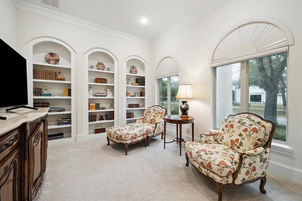 Just off the Front Entry door is the well appointed STUDY (14 X 11) with its carpeted flooring, expansive windows with fan shaped transoms above, wall of painted shelving (ideal for exhibiting fine art pieces or treasured book collections), crown/base molding, recessed lighting and painted walls.