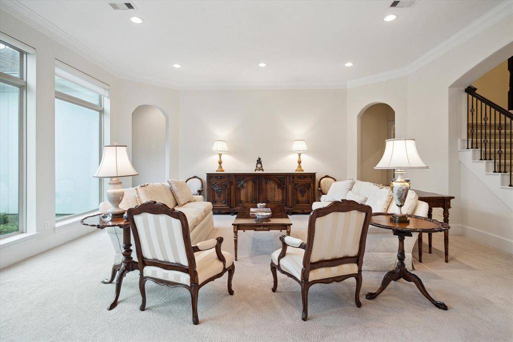 Another view of the Living Room showing the gracefully arched entries to the downstairs bedrooms and the room's close proximity to the front staircase.