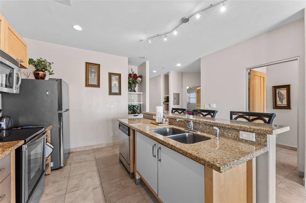 Kitchen includes microwave, range, refrigerator and dishwasher.  Granite counter tops and breakfast bar.