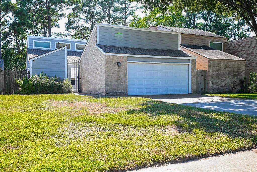 Welcome to your new single-story suburban home, featuring a mix of brick and siding exterior, a two-car garage, and a well-sized front lawn with surrounding mature trees, offering both space and privacy.