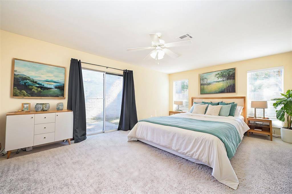 The main bedroom is flooded with natural light, giving it a bright and airy feel. The neutral color scheme and light walls create a cozy and welcoming atmosphere.