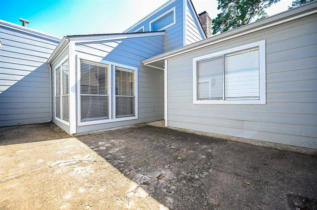 A private courtyard area with a door to the left leads to your 2-car garage, and two bright windows illuminate the breakfast area.