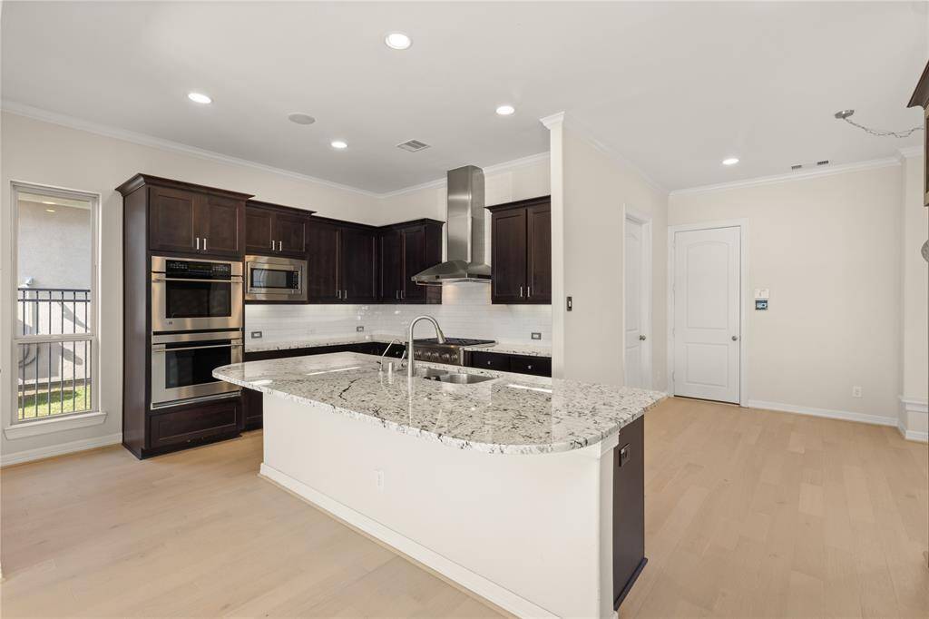Premium GE Monogram stainless steel appliances with a sleek double oven.