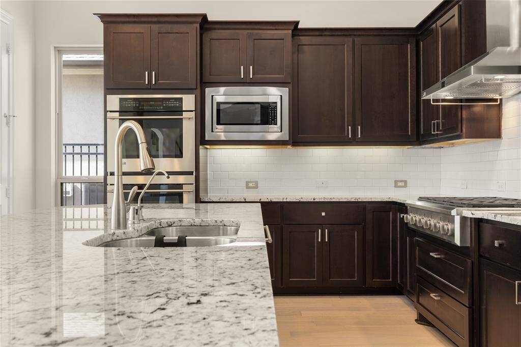 Elegant Benedettini espresso cabinetry paired with stunning granite countertops.