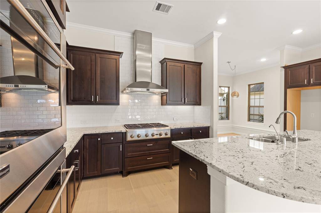 Sleek new white ceramic subway tile backsplash.