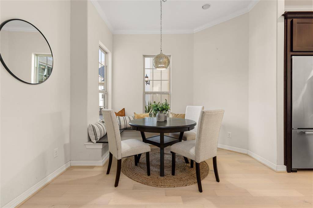 Charming breakfast nook with bay window seating and courtyard views.