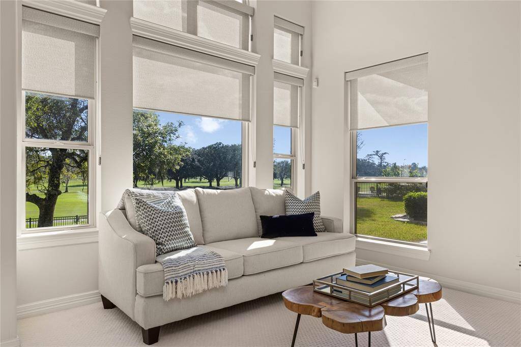 Enjoy stunning golf course views with elegant Hunter Douglas shades.