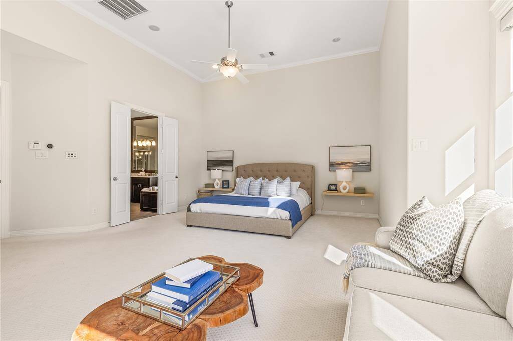 Experience tranquility in the spacious primary bedroom with its cozy sitting area.